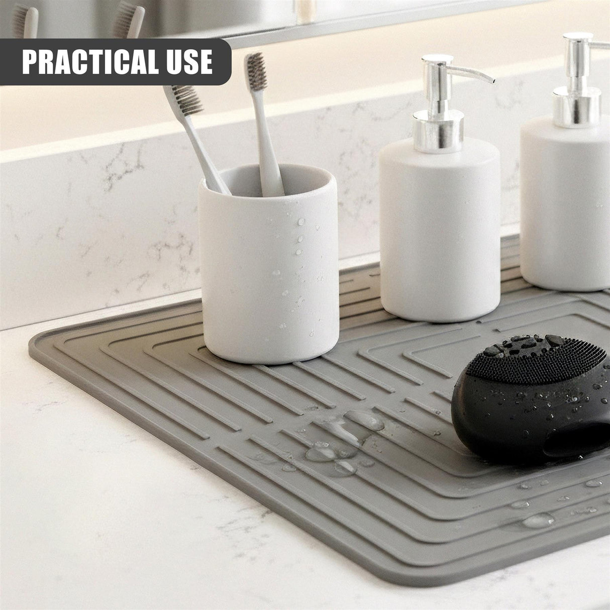 Gray mat holds toothbrushes, two soap dispensers, and a black soap dish.