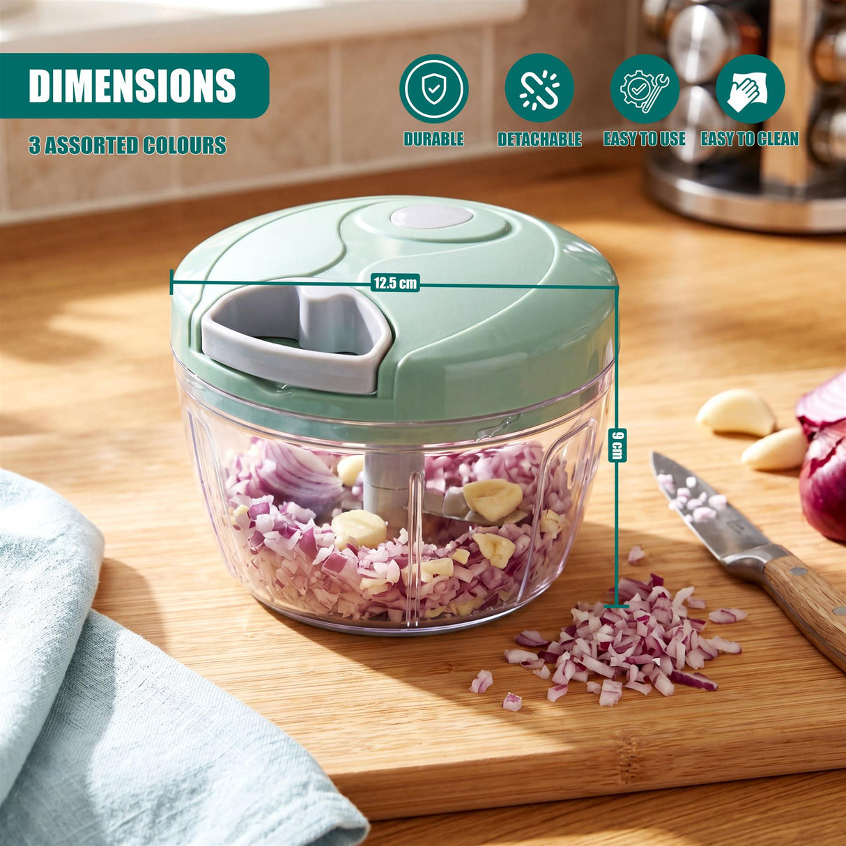 Manual food chopper filled with chopped red onions on a wooden cutting board near a kitchen knife.
