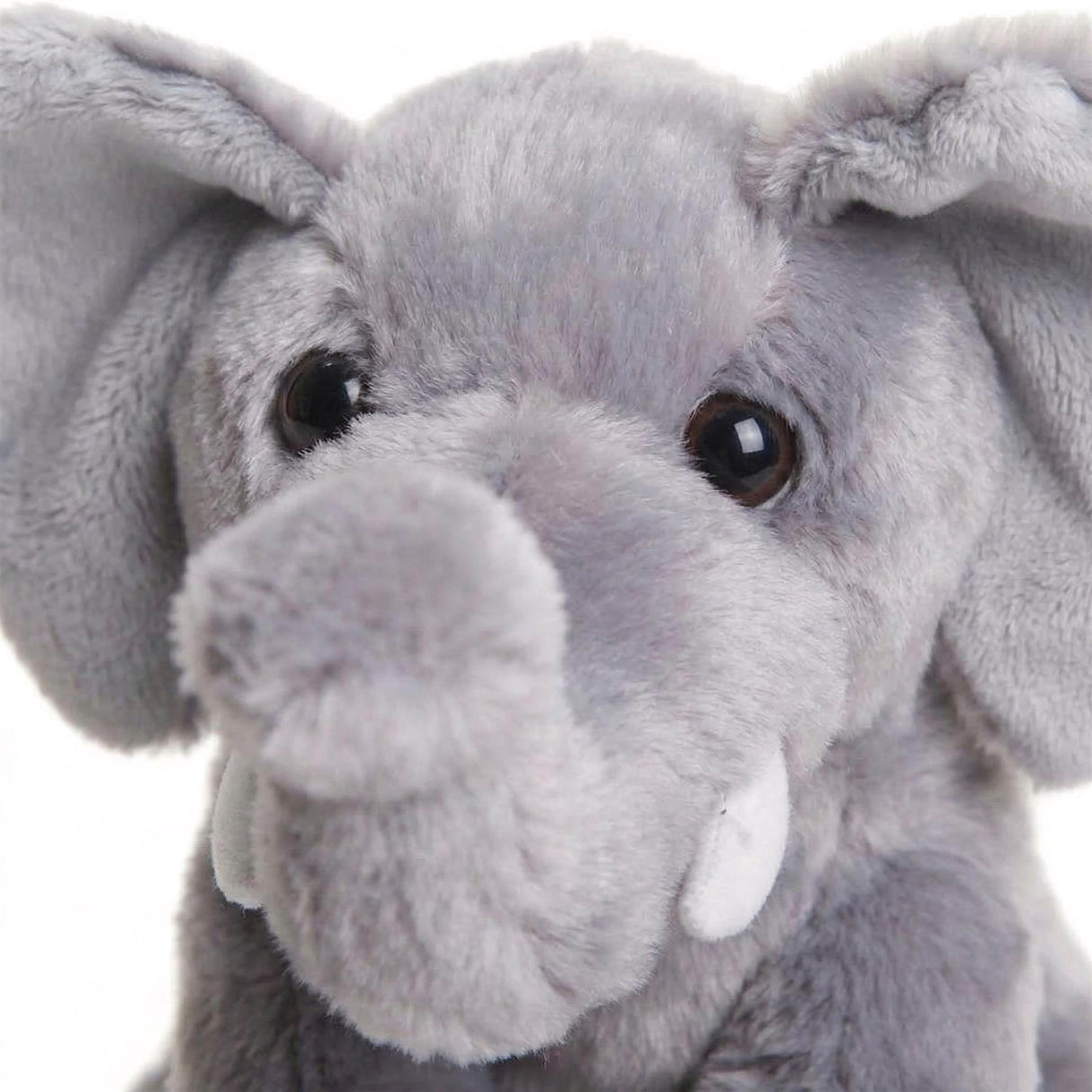 Light gray plush toy of an elephant with floppy ears, tusks, and large eyes.