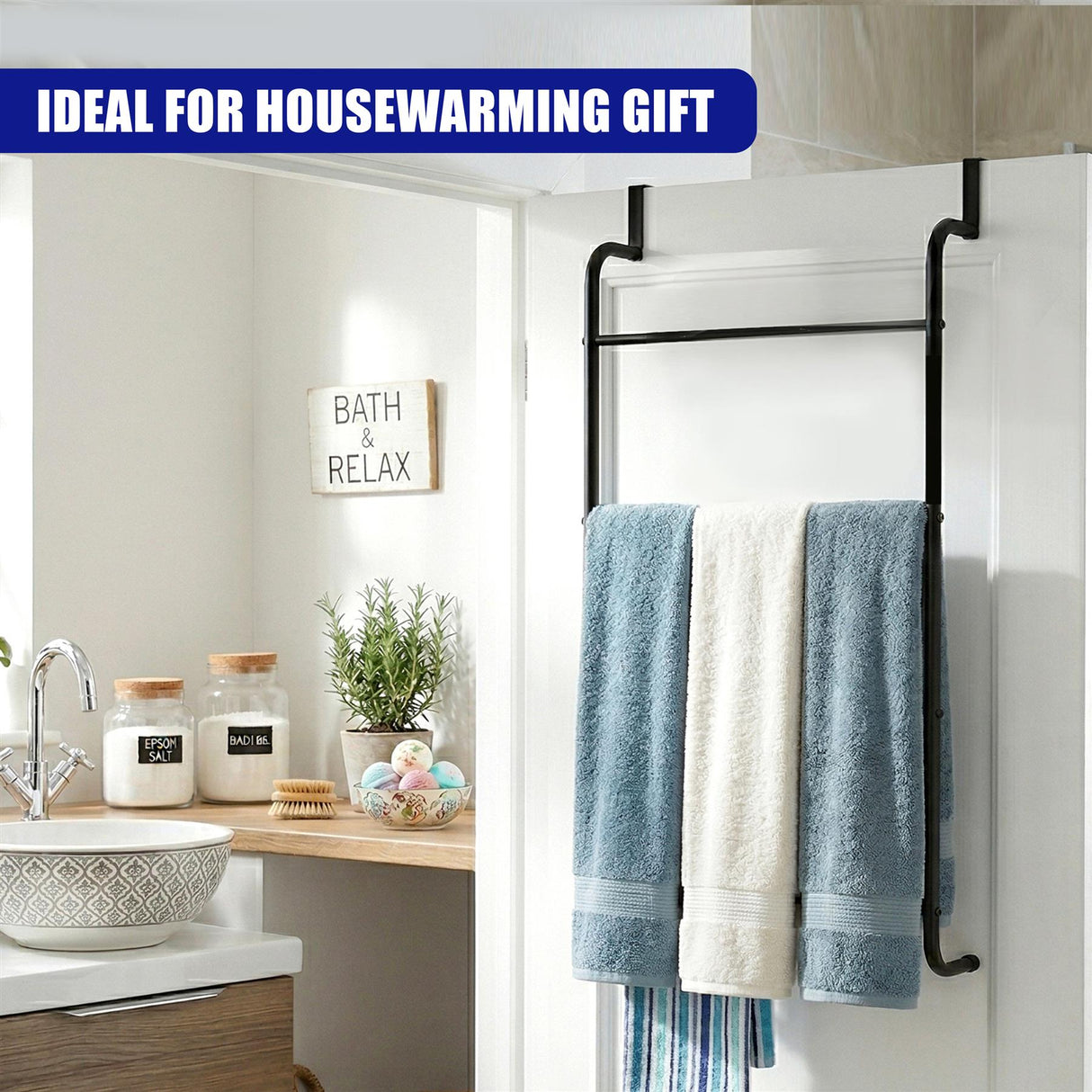 Black ladder-style towel rail installed over a door, holding folded blue, white, and striped towels.