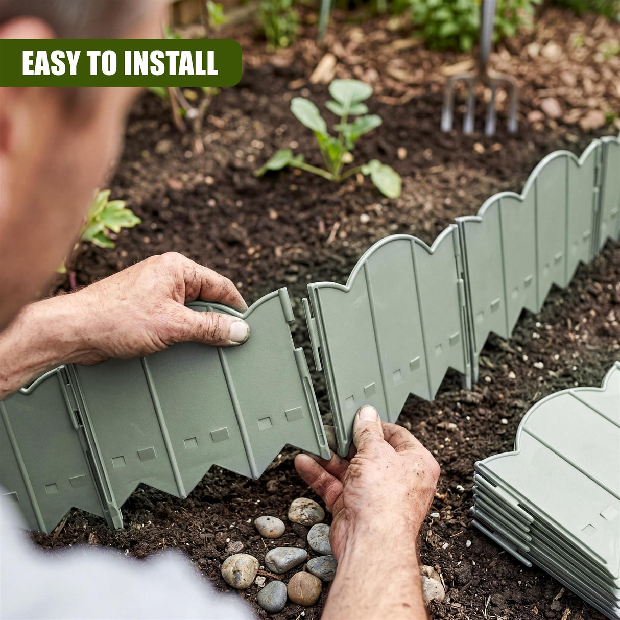 Green garden edging panels are being placed in dark soil, showing slotted sections.