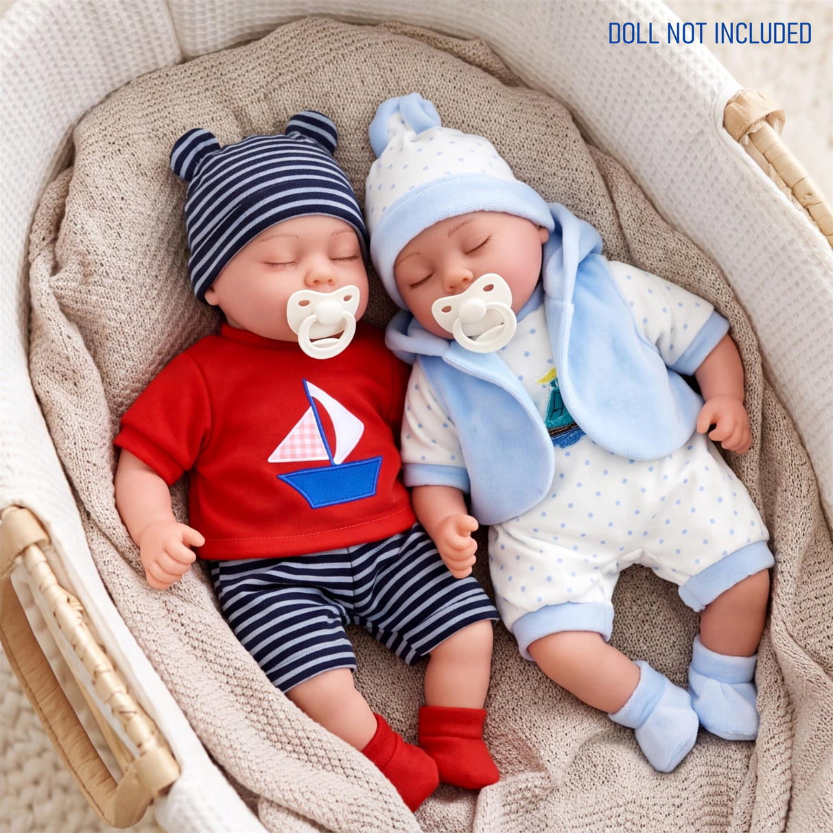 Two dolls rest in a basket, modeled in coordinating baby outfits of red and blue stripes.