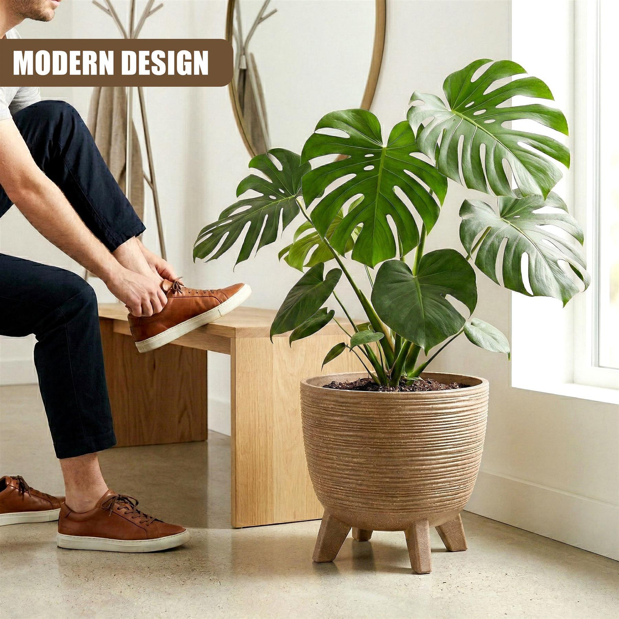 Ribbed brown pot on legs holds a vibrant green monstera leaf plant.