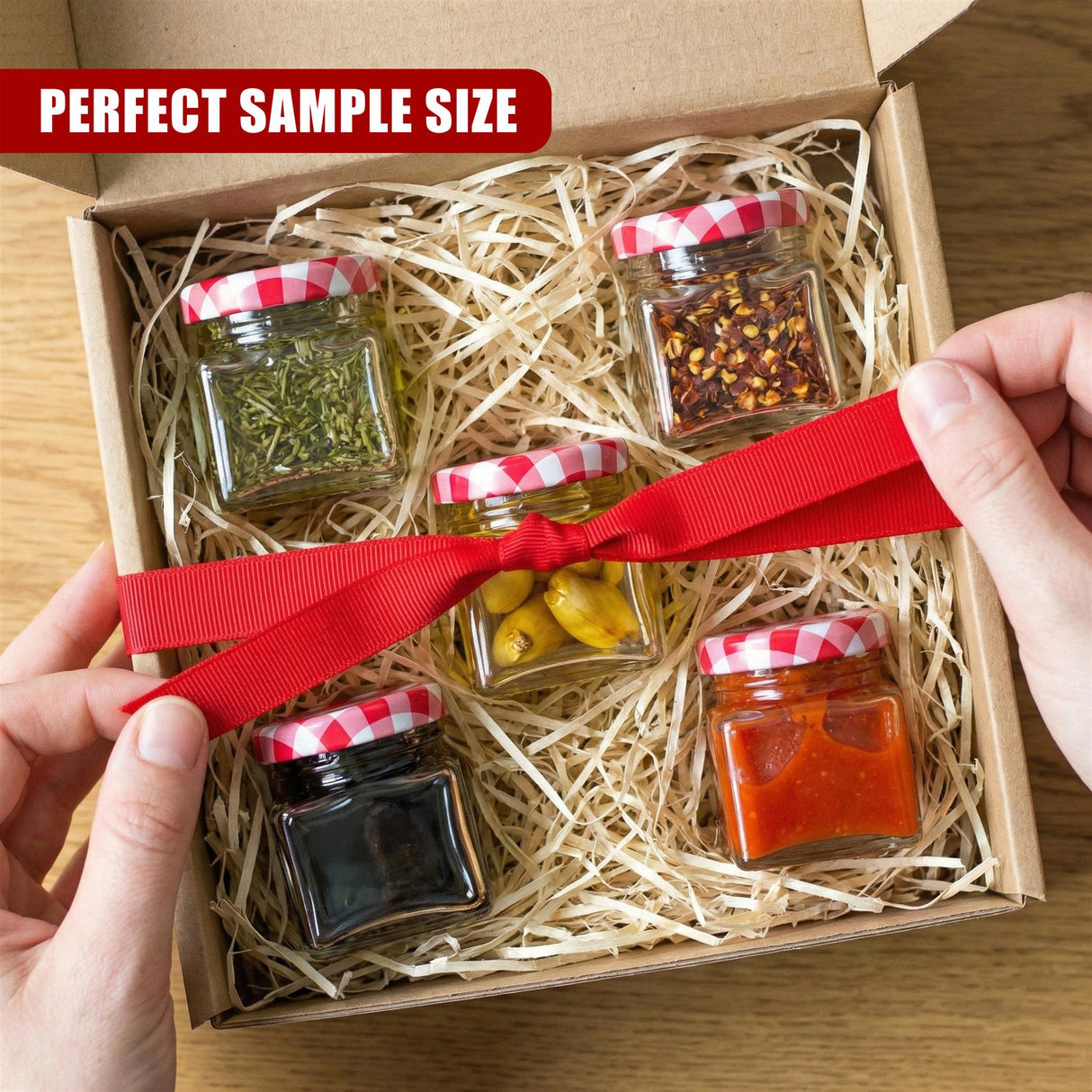 Mini spice jar set: five glass jars holding herbs, spices, and condiments inside an open box.
