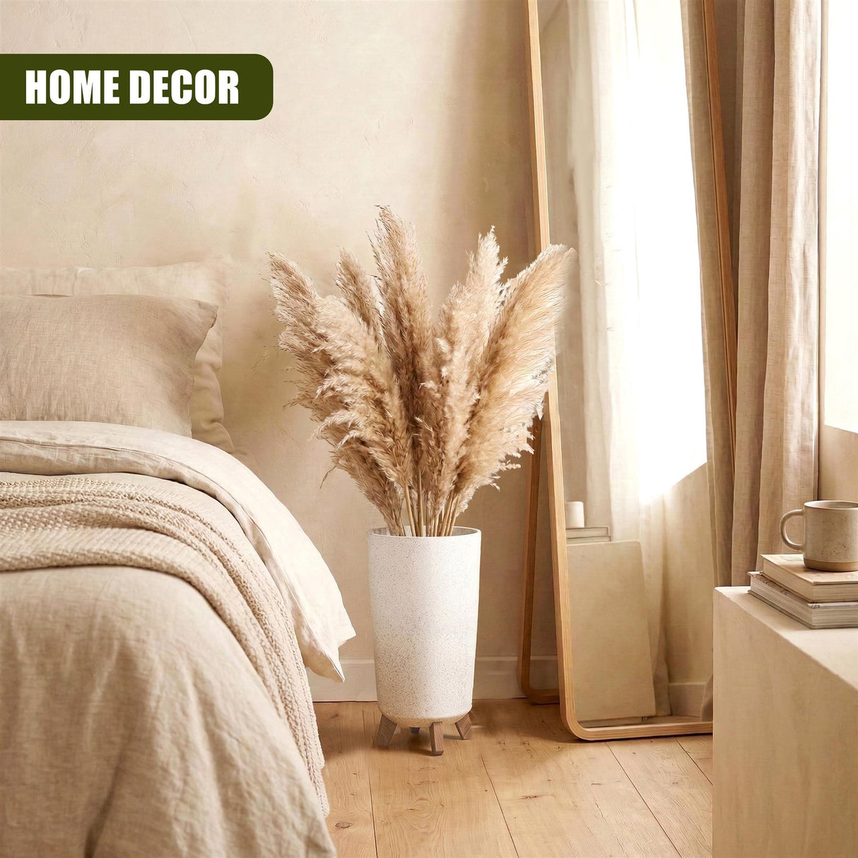 White pot on legs holds a large, fluffy arrangement of dried, beige plume grasses.