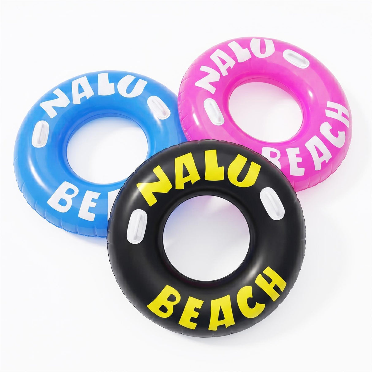 Three inflatable ring toys in blue, pink, and black are printed with the words "NALU BEACH."
