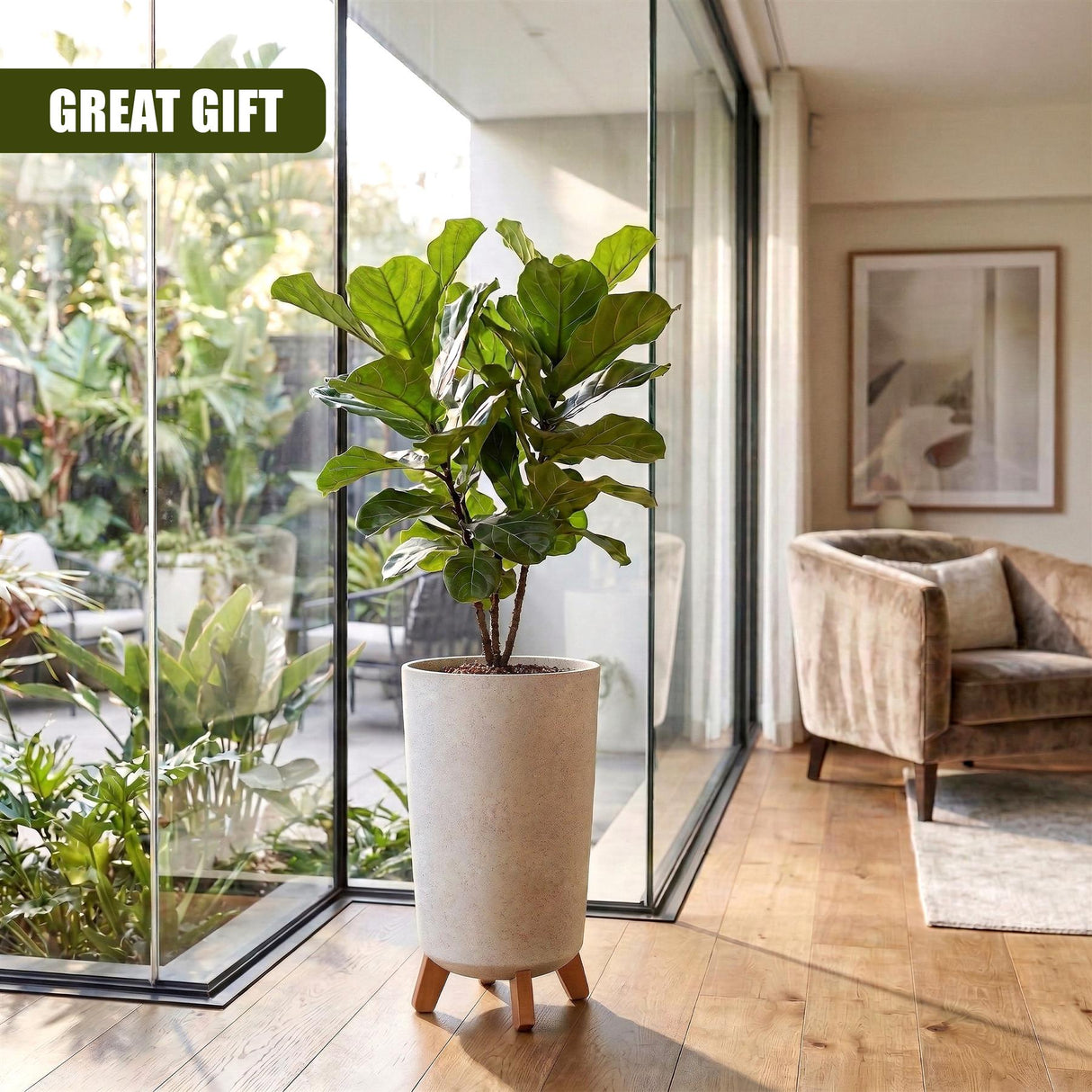 Tan flower pot with short legs displays a lush, green potted plant in a modern indoor setting.