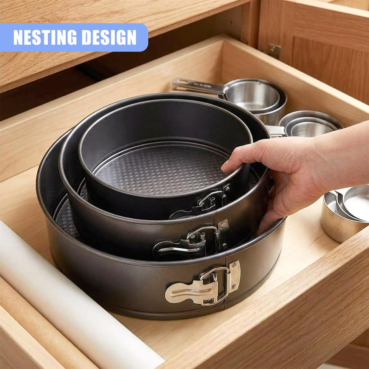 Three nesting springform cake pans, featuring latches, are visible in a wooden kitchen drawer.
