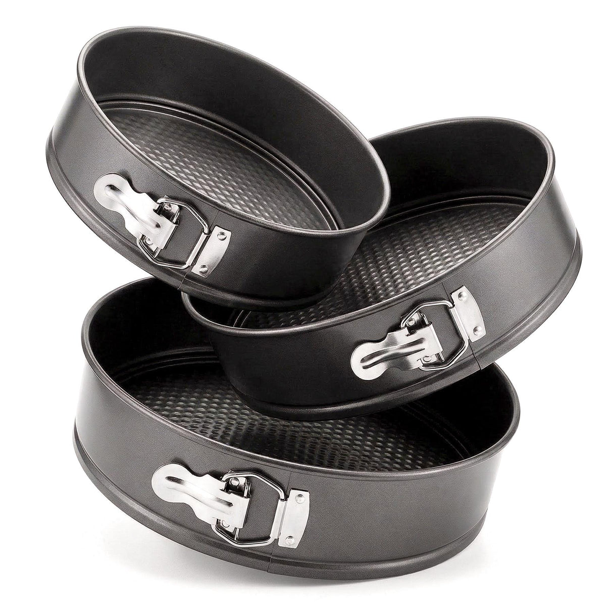 Three sized black springform baking tins are stacked on a white background.