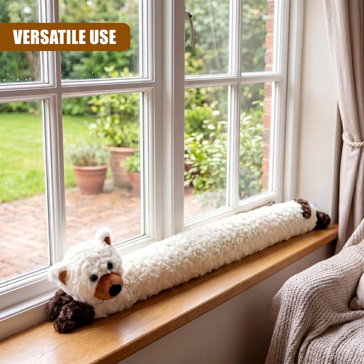 White fabric draught excluder with stuffed animals rests on a wooden window sill.