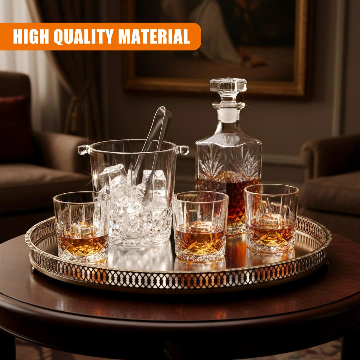 A set of four whiskey glasses, an ice bucket, and a liquor decanter resting on a decorative serving tray.