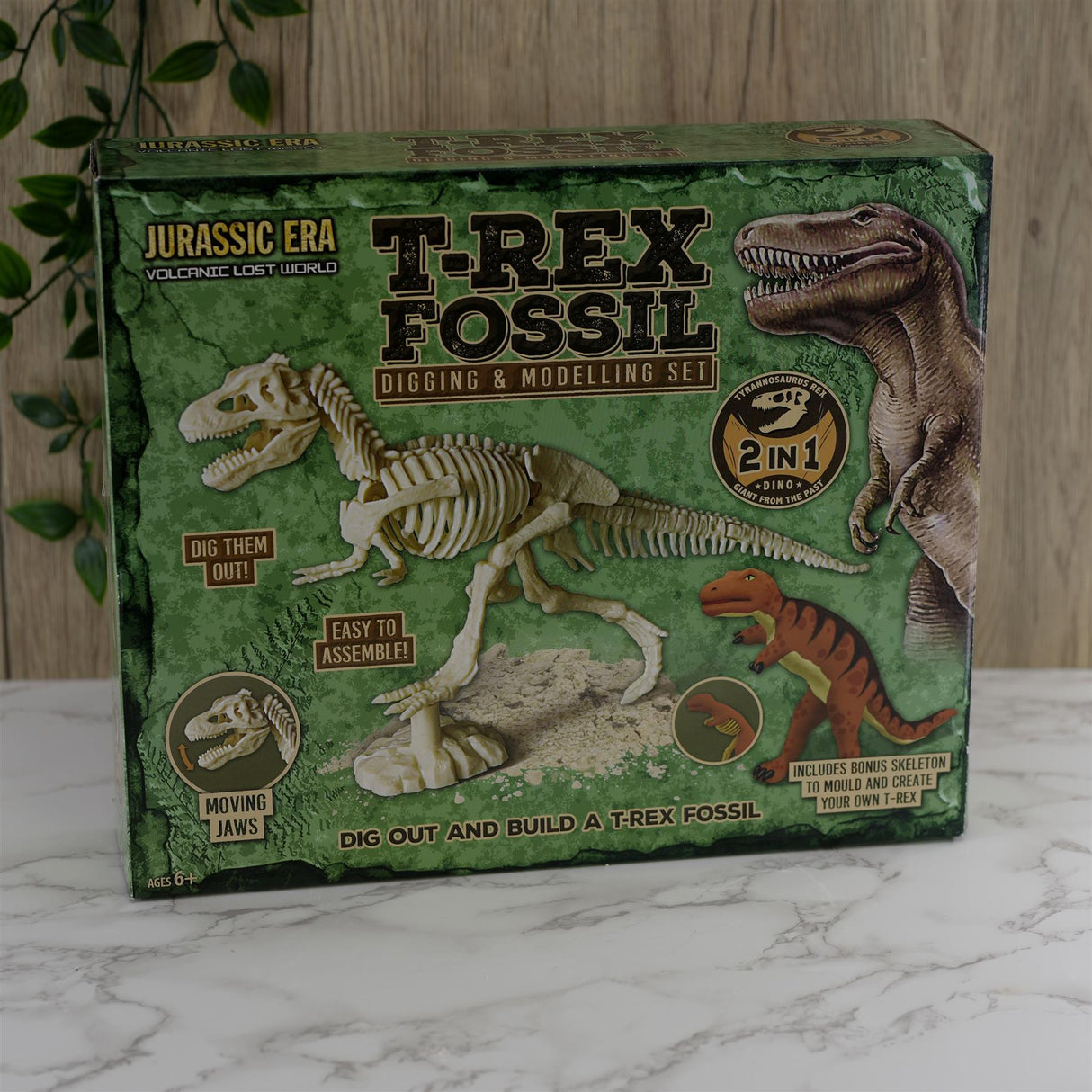 Box showing T-Rex fossil diagram, assembled plastic skeleton, and model kit components.