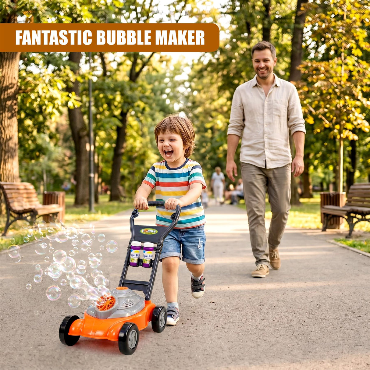 A child pushes an orange bubble machine while an adult walks down a tree-lined path in a park.