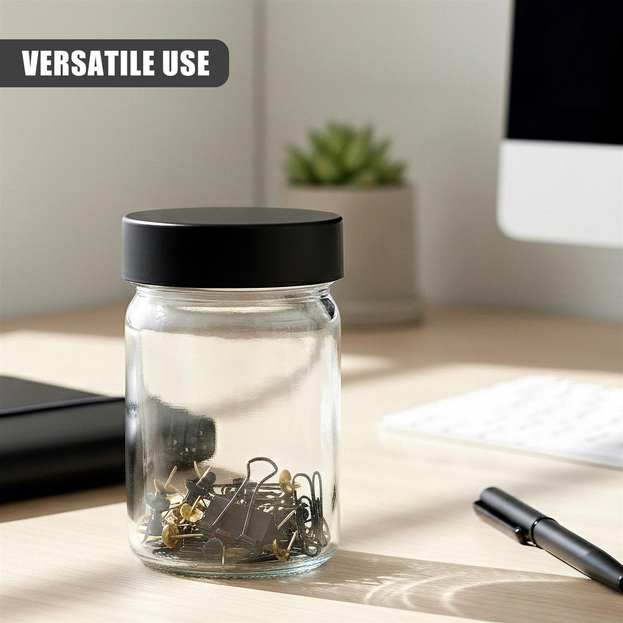 Clear glass jar with black screw lid holding assorted electronic components on a light wooden surface.