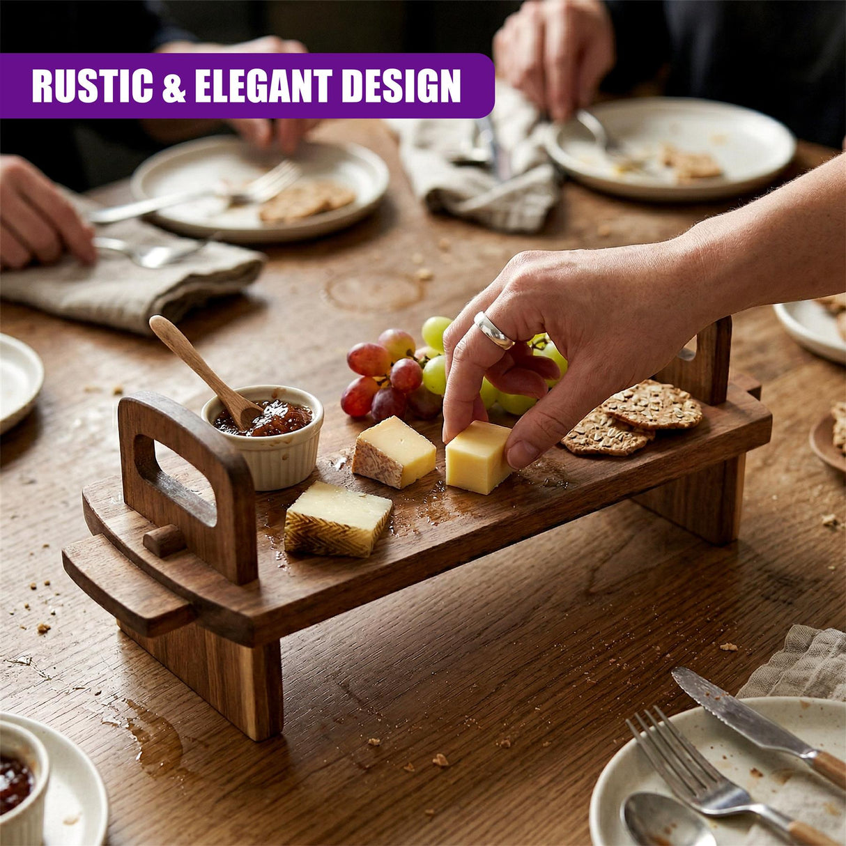 Acacia wood platter filled with grapes, cheese cubes, crackers, and a small dipping sauce.