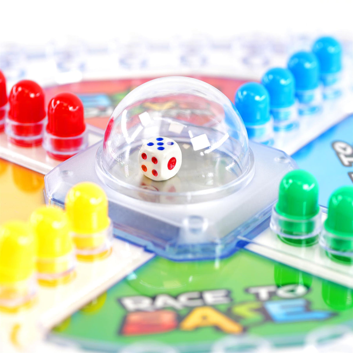 A clear dome covers a die resting on a white base near colored plastic game markers.