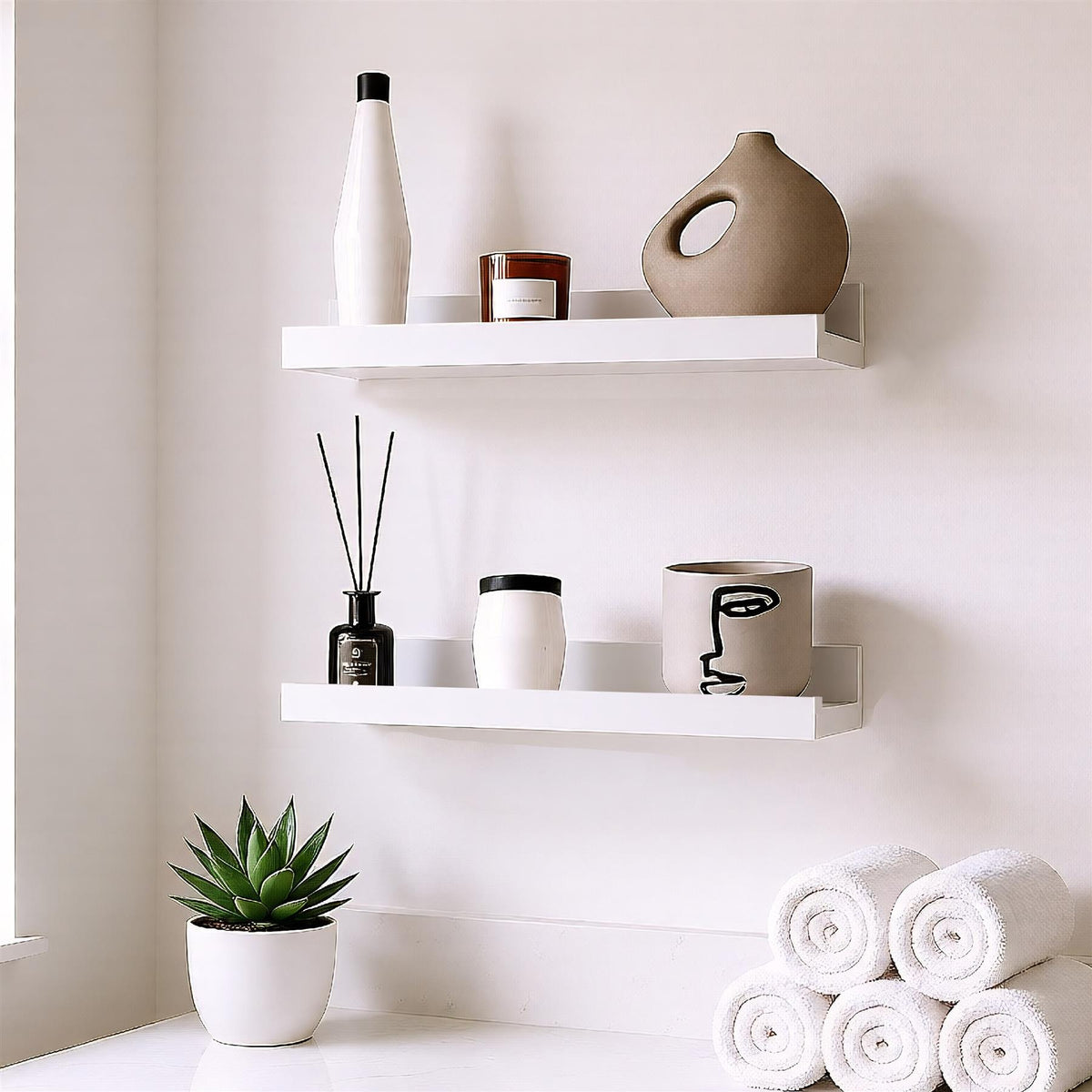 A set of two white floating shelves mounted on a wall, displaying various decorative items including vases and plants