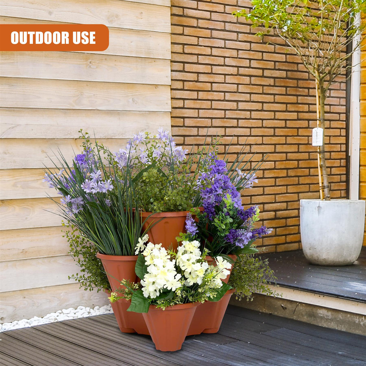 Colorful planter with potted plants and flowers next to a brick wall, showcasing outdoor use and its potential for a porch or patio. - UKBuyZone