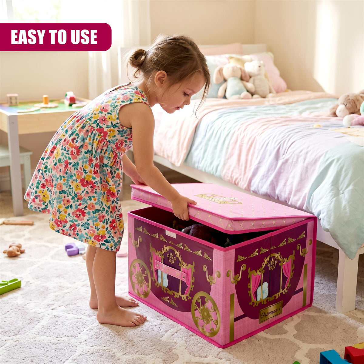 A young girl in a floral dress opens a large pink princess carriage storage box in a child's bedroom