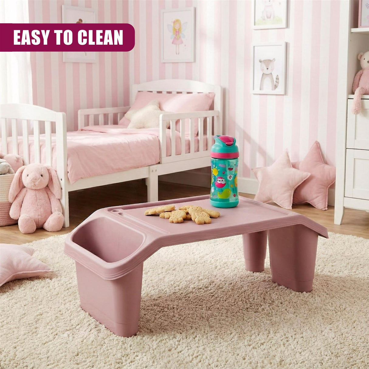 "Pink children's bedroom furniture set: bed, nightstand, and tray table, featuring a cute pink unicorn design on the bed frame and drawer. Also includes a tray table with storage and a small blue container on top, placed in the center of the room. Easy to clean." - UKBuyZone