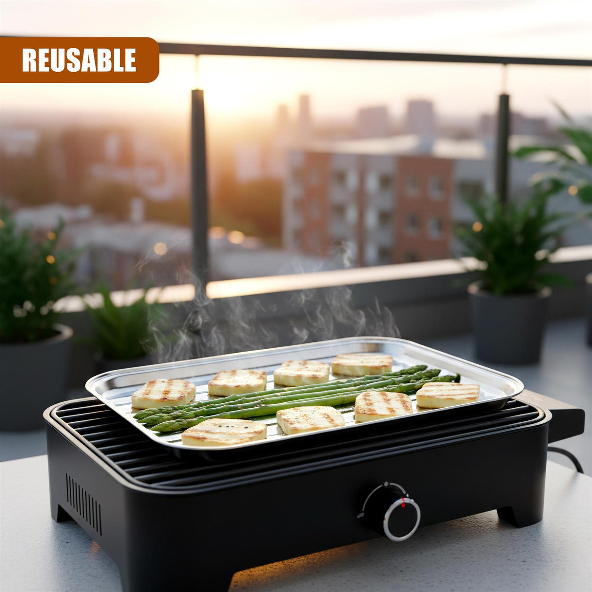 Black outdoor grill unit holding a metal tray with cooked asparagus and sliced bread.
