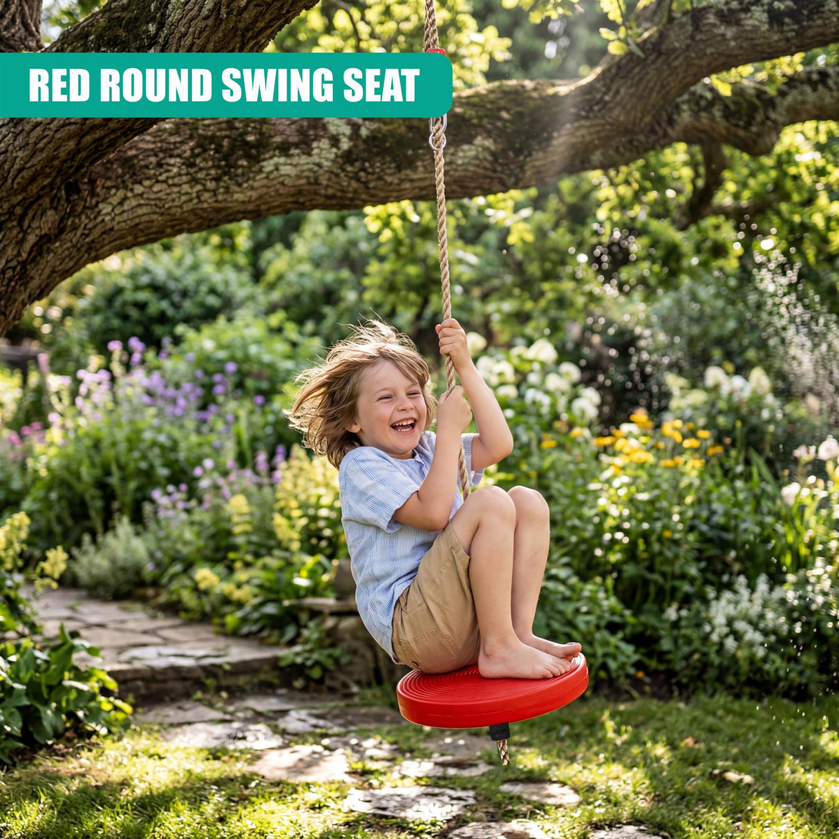 A child swings from a red, round seat suspended by rope under a large tree limb.