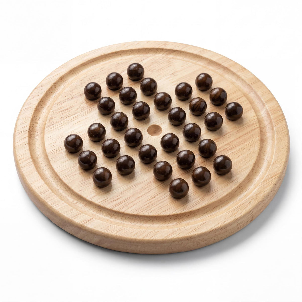 Round wooden game board featuring dark pellets arranged in a distinct pattern.