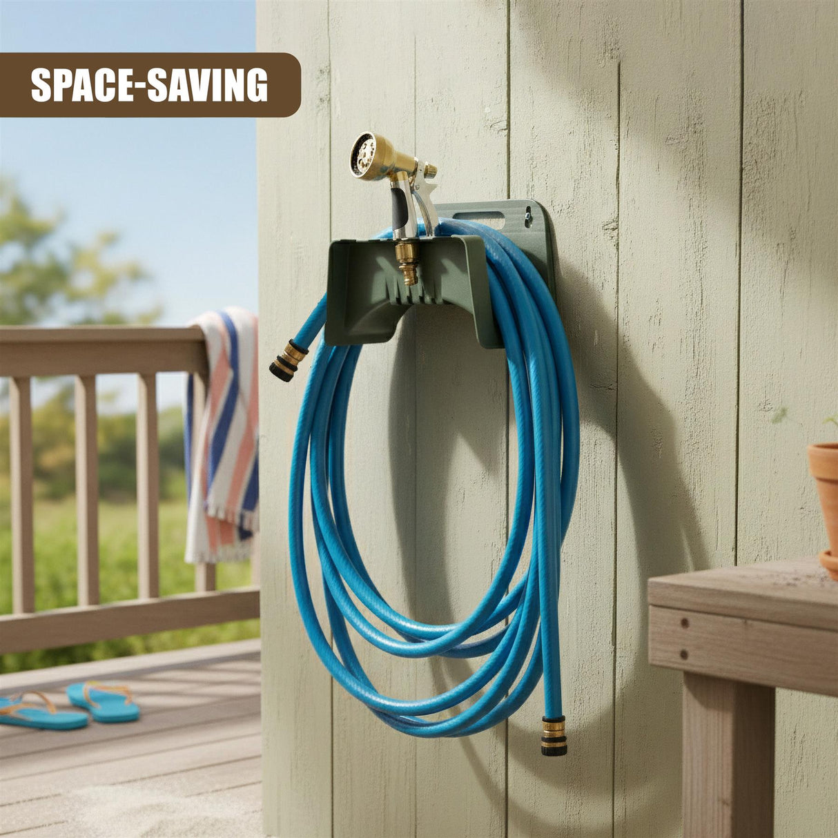 A dark metal hose holder with a spigot and a coiled blue garden hose mounted on wood siding.