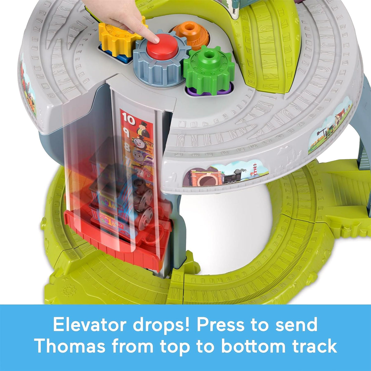 The toy shows a train descending from an elevated platform to a green train track below.