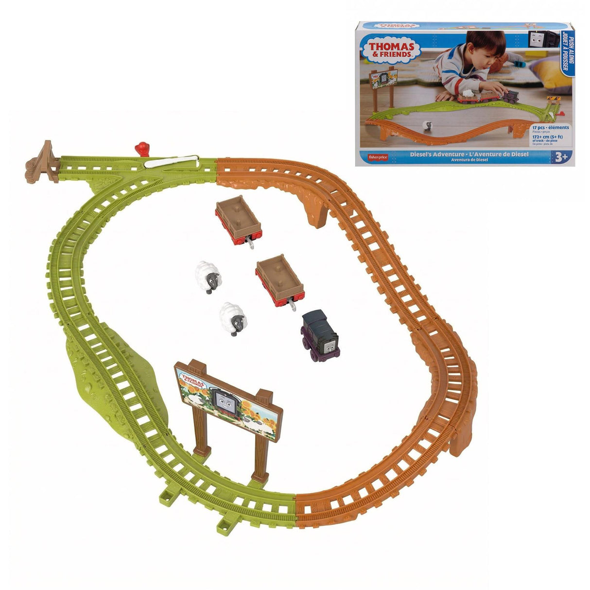 Assembled train track set features curved green and brown segments, three engines, and a central station piece.