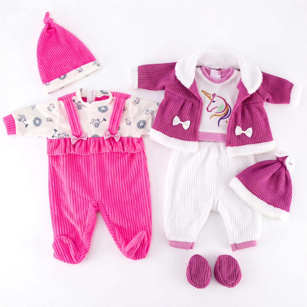 Two sets of doll outfits: pink jumpsuit and hat, paired with white and purple unicorn apparel.