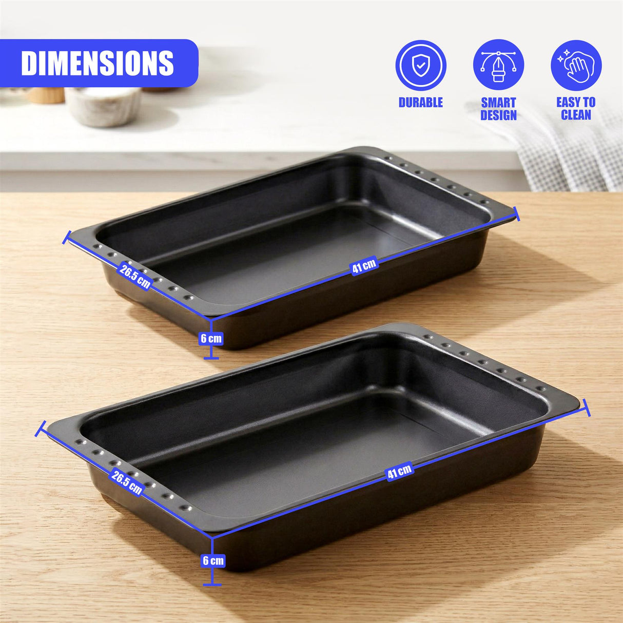 Set of two dark roasting tins, each measuring 41 cm by 26.5 cm, placed on a wooden surface.