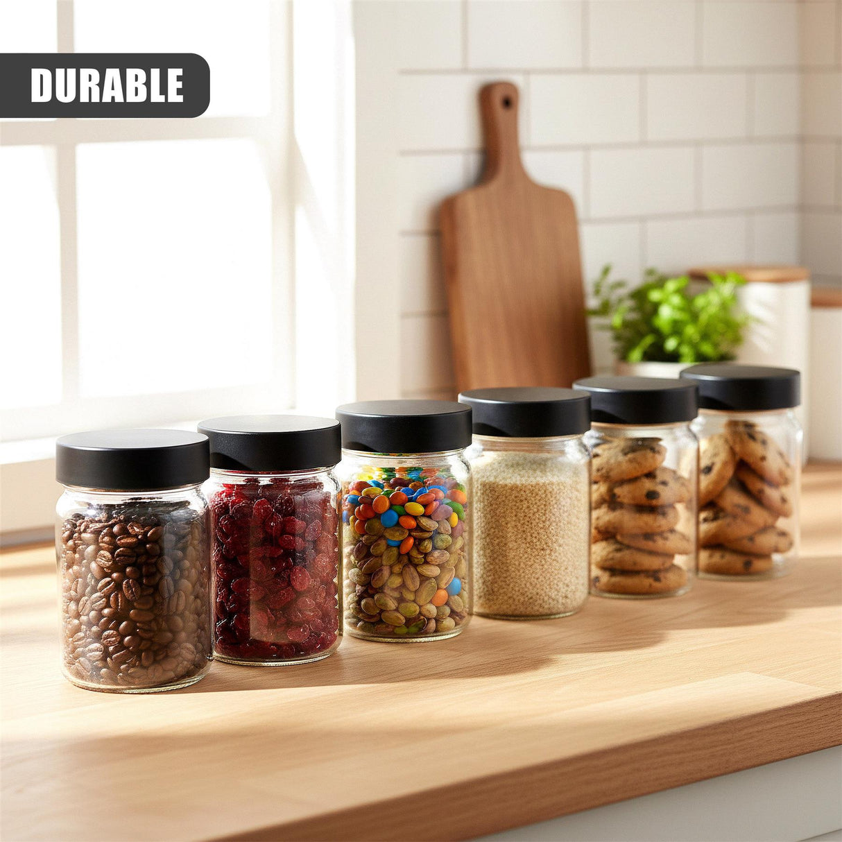 A set of six glass jars displaying various colorful spices, grains, and dry kitchen goods.