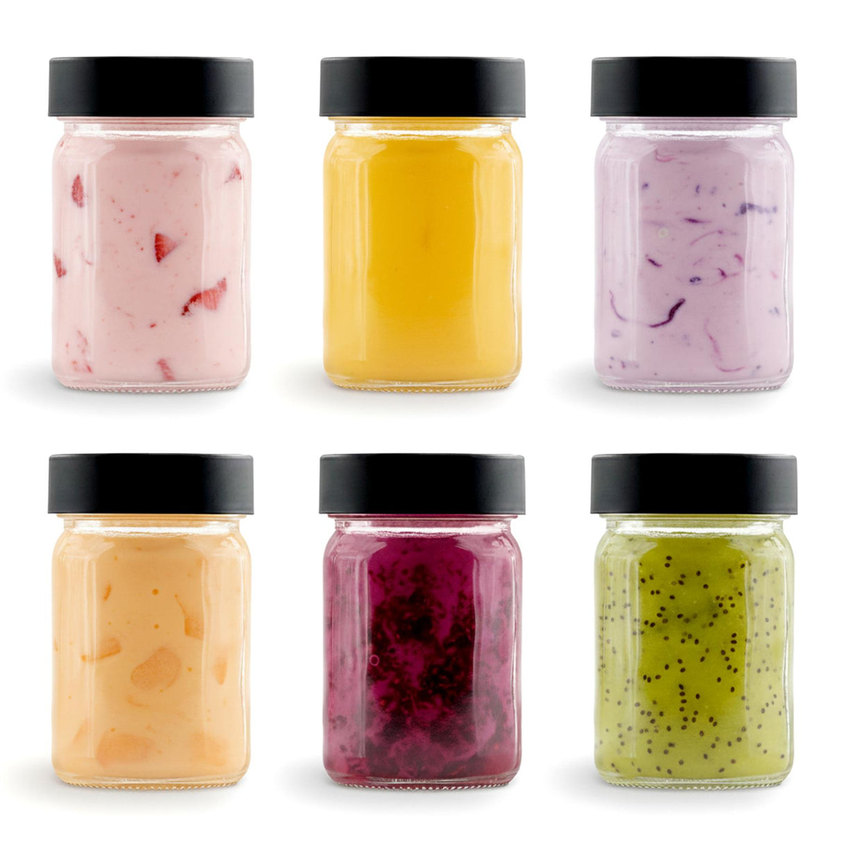 Six small glass jars with black lids holding various colored powdered seasonings.