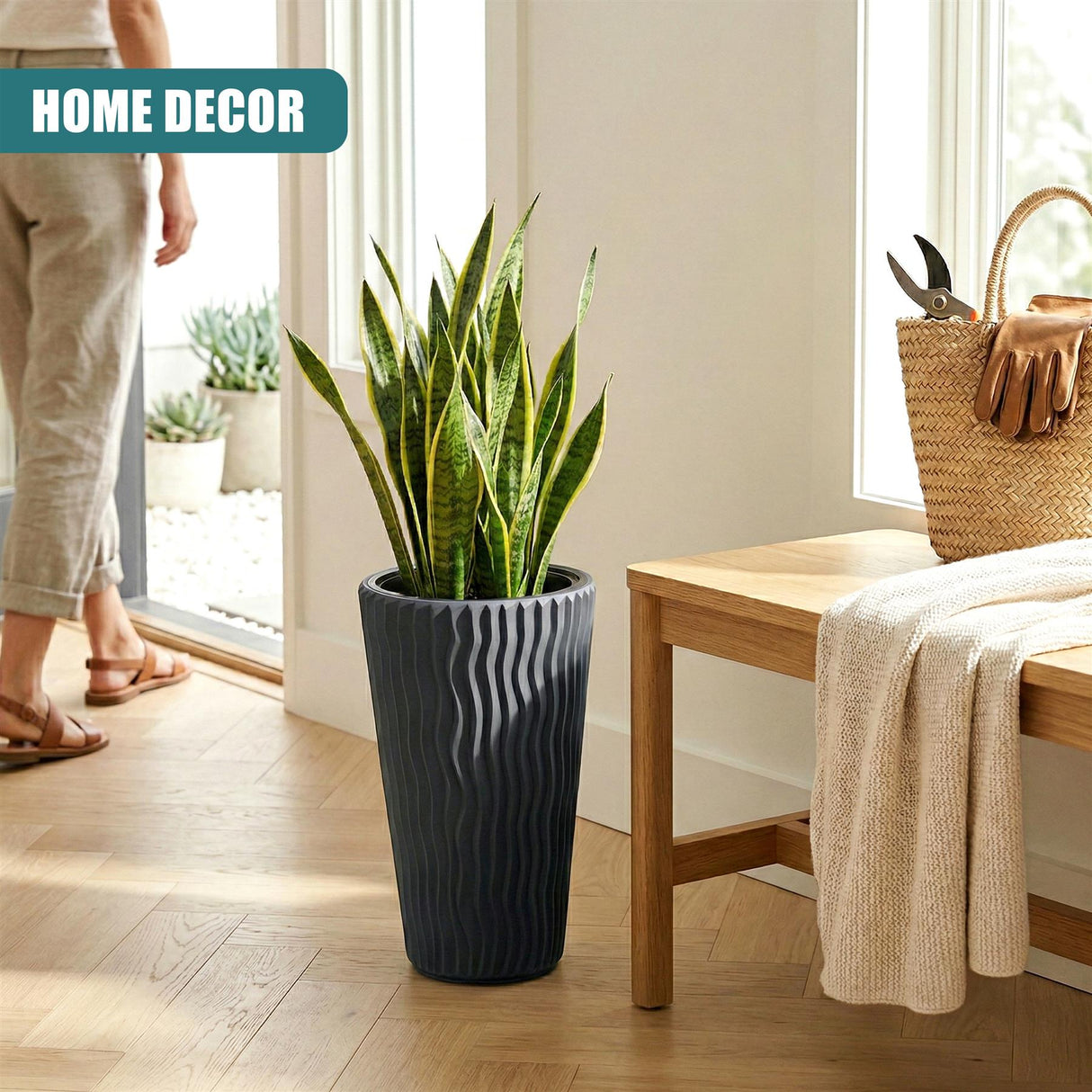 Tall anthracite planter with vertical ridges holding vibrant green indoor foliage plants.