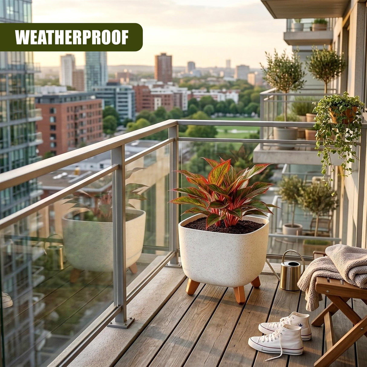 Cream ceramic flower pot with wooden legs holds a vibrant tropical plant on a wooden balcony.