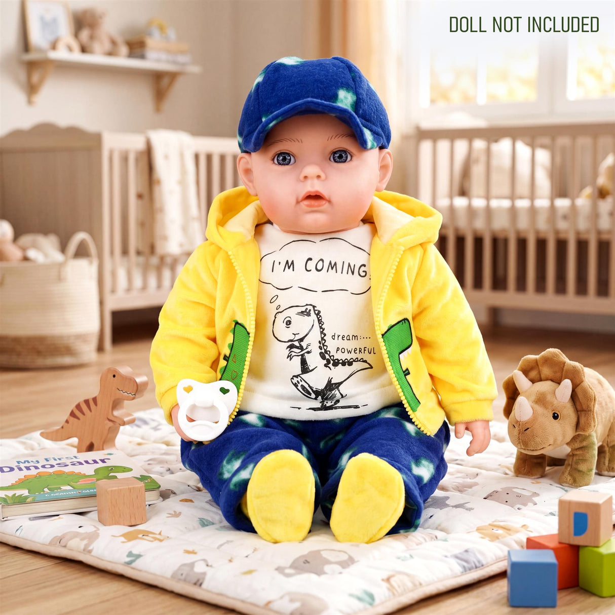 Doll modeled in a yellow hoodie and blue pants featuring a dinosaur graphic.