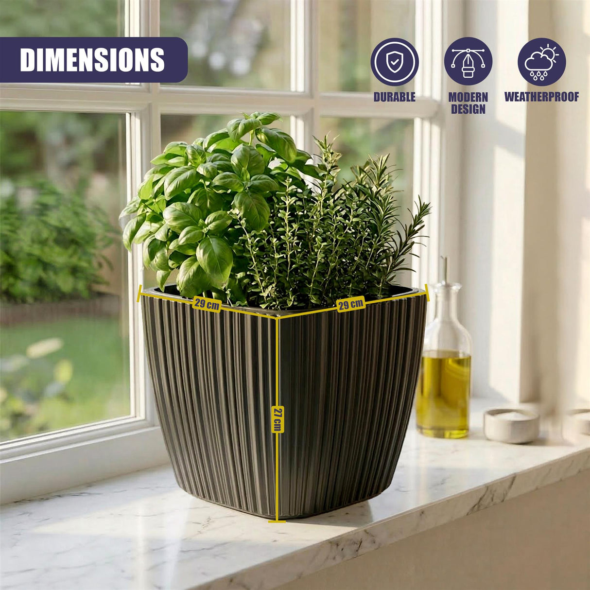Black vertical planter filled with green herbs rests on a light-colored windowsill.