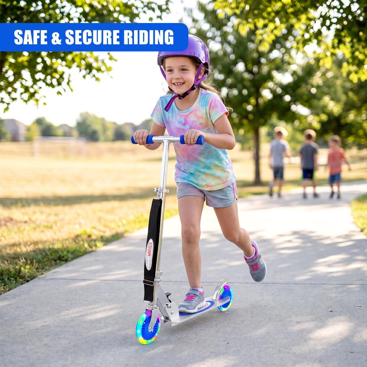 A child stands on a blue scooter with bright wheels on a paved walkway.
