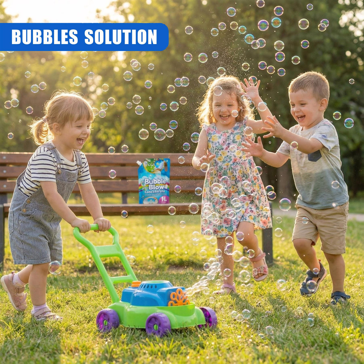 A bubble machine and concentrate container sit on the grass near four children playing outdoors.