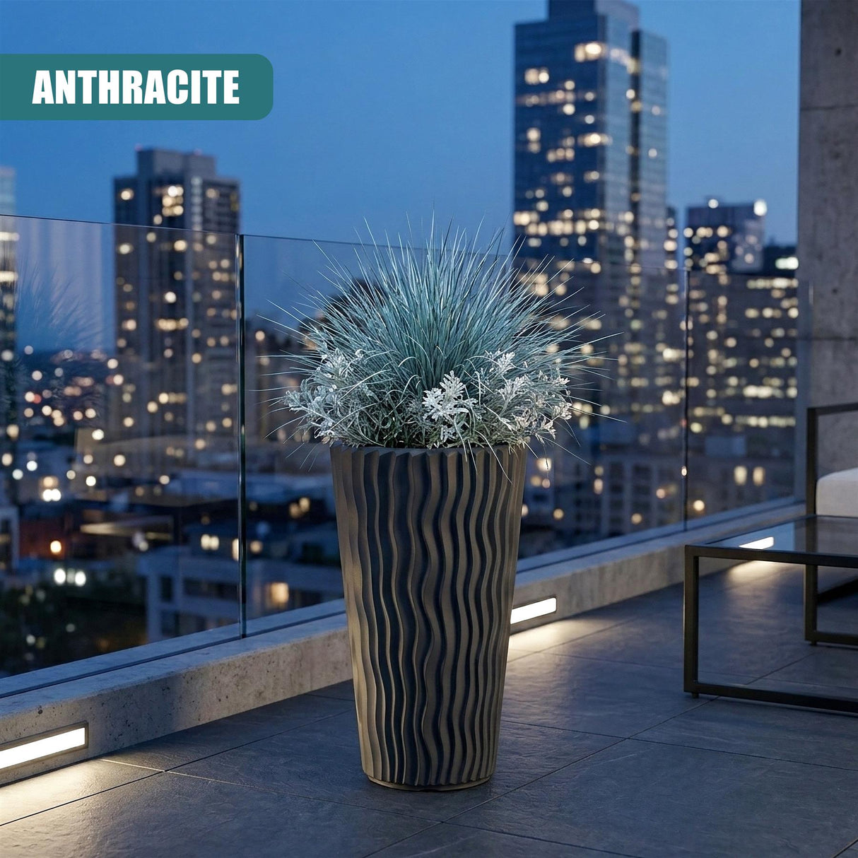 Tall anthracite planter with vertical stripes, holding a silvery-blue potted plant.
