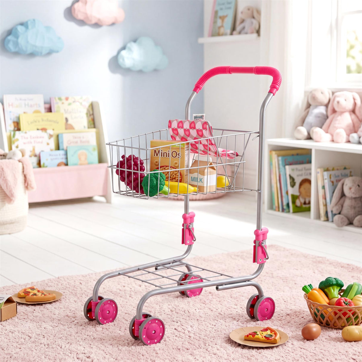 Kids' metal shopping trolley with pink accents, containing plastic toys and play food.