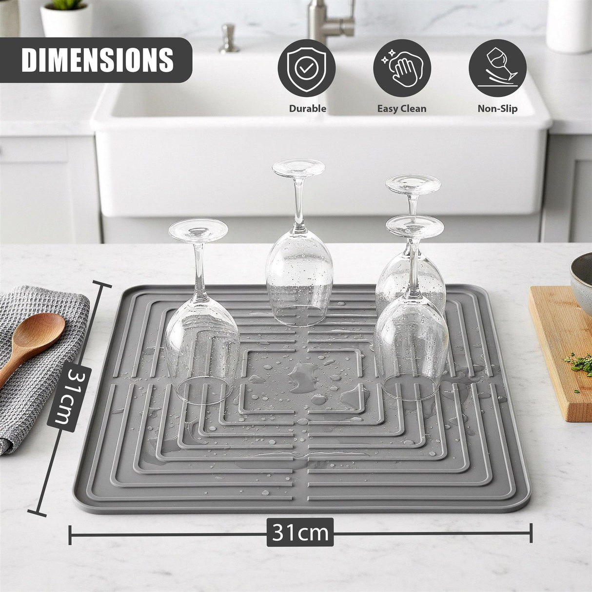 Rectangular gray drying mat with patterned drainage slots holding three wine glasses.