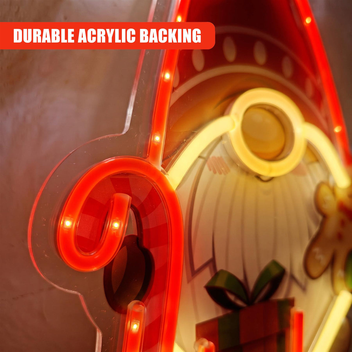 A red and yellow LED neon sign shaped like a Santa gnome wearing spectacles, featuring a gift box and gingerbread man design