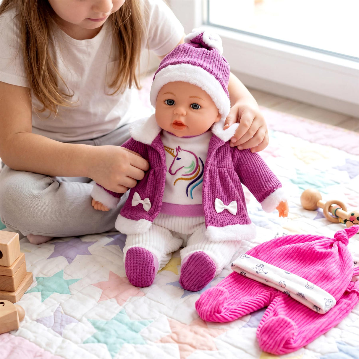 A doll wears a purple unicorn outfit next to matching hot pink sleeves and pants.