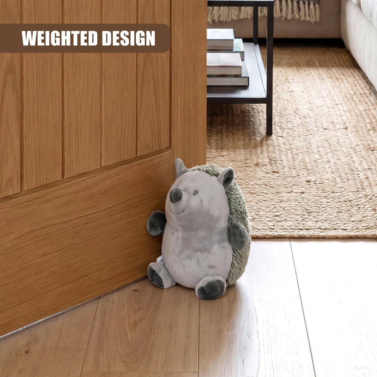 Plush novelty hedgehog door stopper with gray fur and green quills resting against a wooden door.