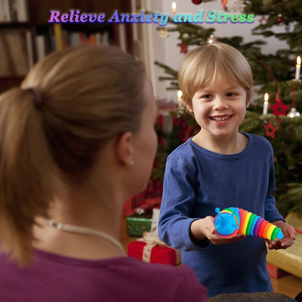 Boy holding a multi-colored, ribbed fidget slug toy while facing the camera.