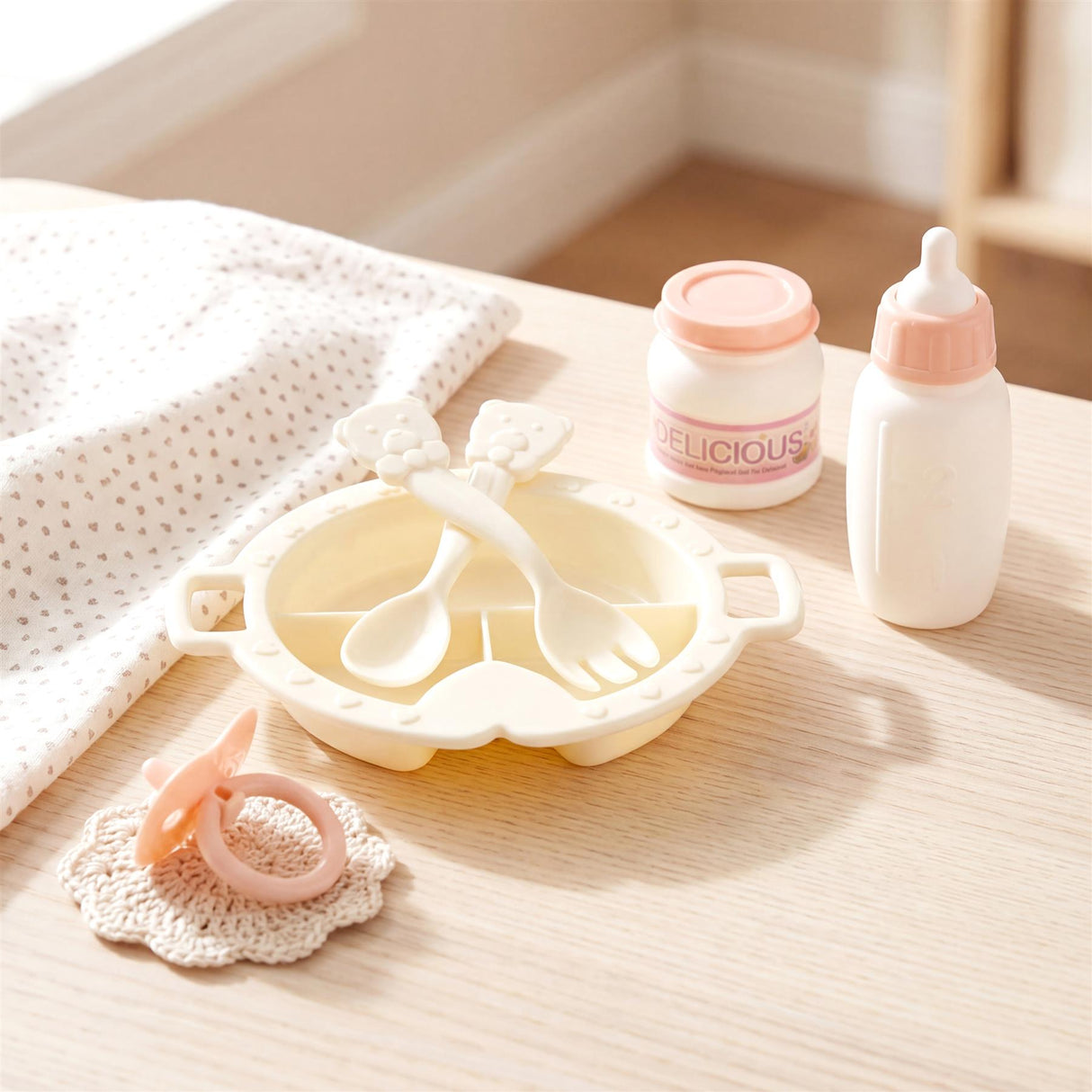 Toy set features a feeding high chair, utensils, baby bottle, jar, and teething rattle on a table.
