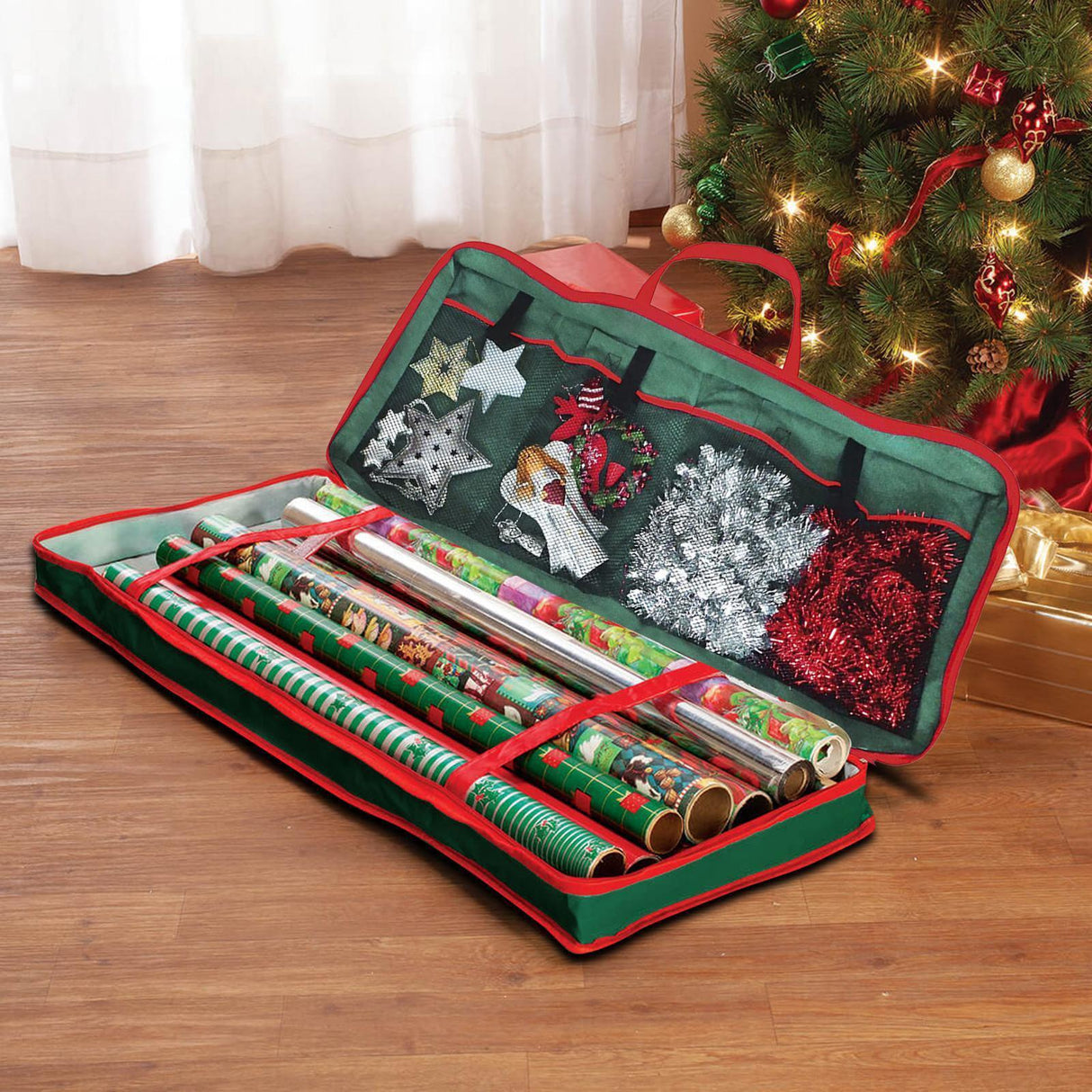 A green and red storage case with a hinged lid, filled with rolls of Christmas wrapping paper and a few gift items. - UKBuyZone
