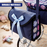 Blue canvas storage pouch attached to a pram, featuring a bow and patterned side panels.